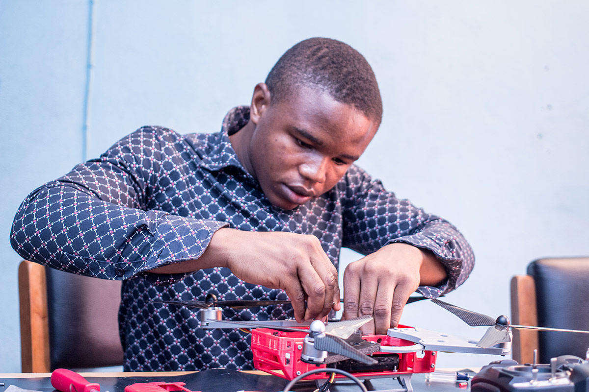 A young man building a prototype drone. Credit: 3D Africa/YTF